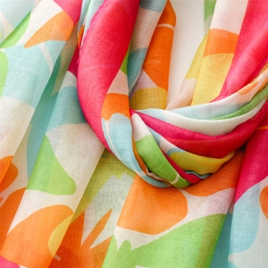 Detail of colorful floral printed voile scarf with soft texture and vibrant patterns