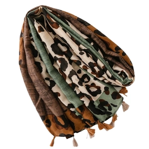 Green leopard print cotton linen feel scarf with fringes shown on white background