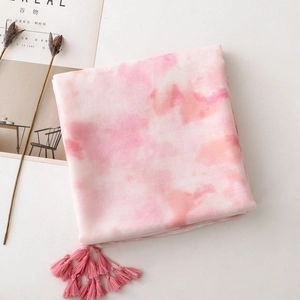 Close-up of pink ink-wash gradient cotton scarf with fringe and soft linen texture