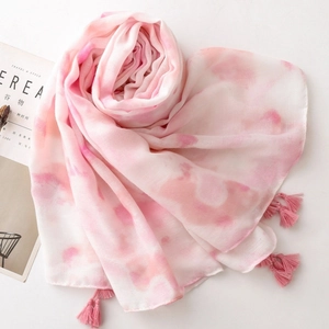 Detail of pink and white gradient scarf with fringe tassels and soft cotton-linen texture
