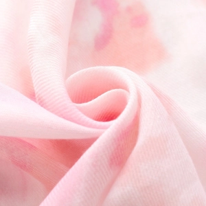 Detailed macro view of pink and white gradient cotton linen scarf with twill weaving texture