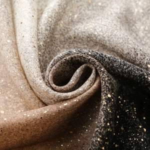 Macro detail of gradient linen-feel scarf fabric with elegant gold foil speckled texture