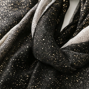 Detail of black cotton-linen scarf with gold foil dots and elegant gradient effect