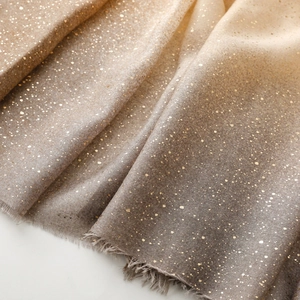 Detail of gradient cotton linen scarf with gold foil dots and elegant fringe edges