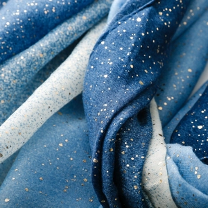 Detail view of cotton linen scarf with blue gradient and gold foil dot patterns