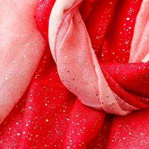 Detailed macro shot of red and pink gradient cotton linen scarf with gold foil accents