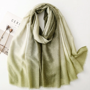 Detail showing forest green gradient linen scarf with gold speckles and frayed edges