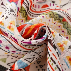 Close-up of bohemian scarf fabric showing colorful geometric patterns and texture