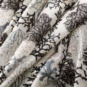 Detailed close-up of cotton linen scarf featuring gold foil coral patterns and branch prints