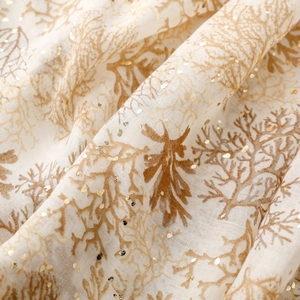 Detail of coral print scarf with gold foil accents on soft linen-feel fabric