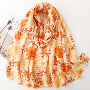 Linen feel coral print scarf with gold stamping and delicate fringe edges on white