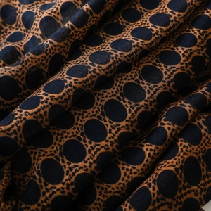 Detail shot of bohemian bali voile scarf texture with blue dots and tassels