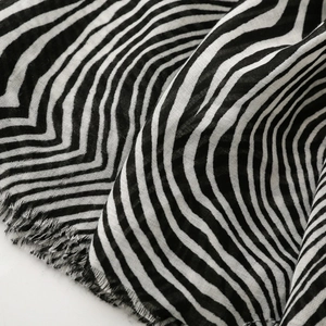 Detail of black and white zebra print scarf fabric with soft frayed fringe edges