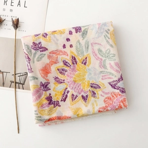 Detailed view of floral cotton silk scarf with fringe edge and vibrant embroidery