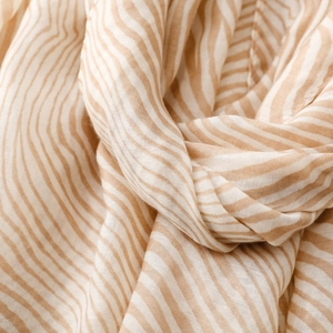 Macro view of zebra stripe scarf showing breathable cotton-linen blend fabric texture