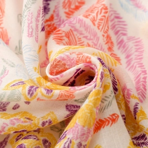 Detail of floral geometric print scarf showing soft cotton texture and vibrant abstract leaves