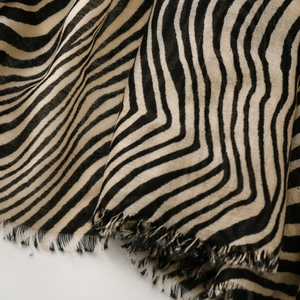 Close-up of zebra pattern scarf showing soft cotton texture and fringed edge details