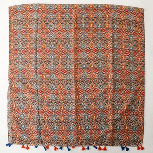 Bohemian style tassel shawl featuring geometric patterns in orange and navy blue