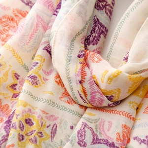 Close-up of colorful Bohemian print scarf showing soft fabric texture and feather patterns