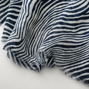 Close-up of zebra pattern cotton scarf showing soft texture and frayed fringe edges