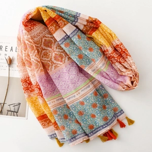Bohemian style colorful scarf with ethnic floral patterns and tassel charms on white backdrop