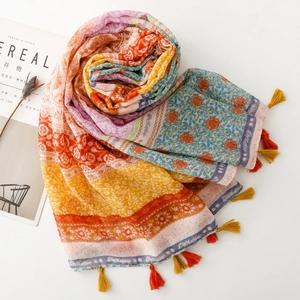 Detailed close-up of ethnic print scarf with wheat pattern and decorative tassels