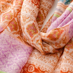 Detailed close-up of bohemian floral print scarf with vibrant mixed colors and soft texture