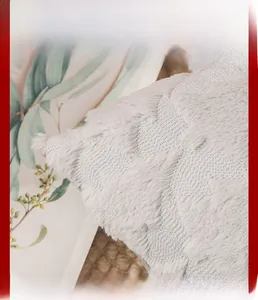 Close-up of gray plush pillowcase featuring embossed 3D heart pattern and soft texture