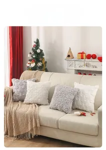 Detail of plush Christmas pillow covers with embroidered snowflake pattern on sofa