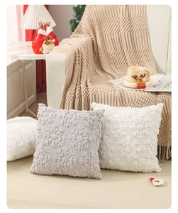 Close-up of plush Christmas pillow cover with 3D snowflake embroidery in a cozy home setting