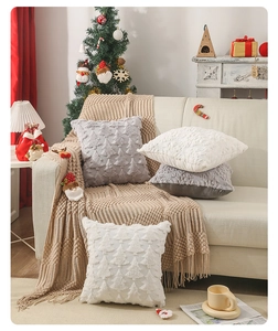 Detail of plush Christmas pillow cover featuring embossed tree patterns on a white sofa