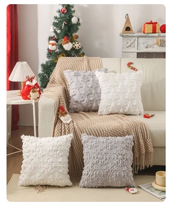 Detailed view of plush Christmas pillow covers with embossed snowflake and tree patterns