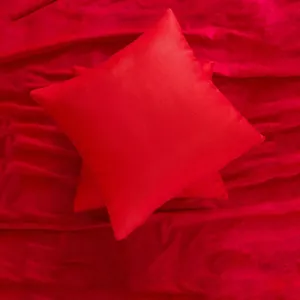 Traditional red Chinese wedding pillow with gold embroidery on plush fabric for decor