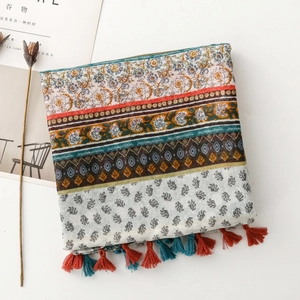 Detail of bohemian scarf with ethnic floral print and colorful tassel edges