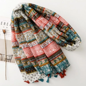 Detail of bohemian floral print scarf featuring vibrant geometric patterns and fringe tassels