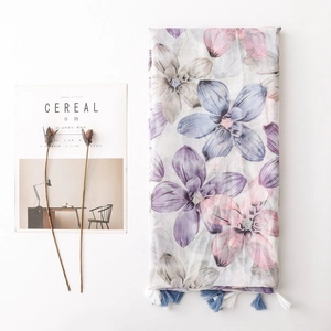 Floral print voile scarf with tassels featuring pastel blue and purple flower patterns