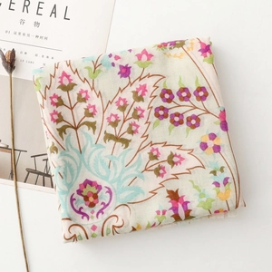 Detail of floral printed scarf with boho patterns, styled with Cereal magazine and dried flowers