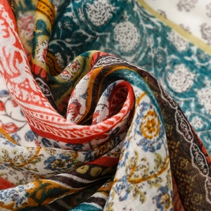Close-up of lightweight Bali yarn scarf with ethnic paisley print and fringe detail