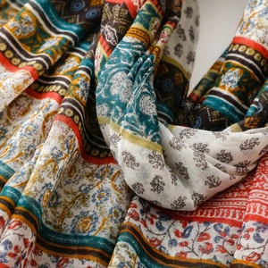 Close-up detail of Bohemian scarf fabric showing ethnic floral print and soft woven texture