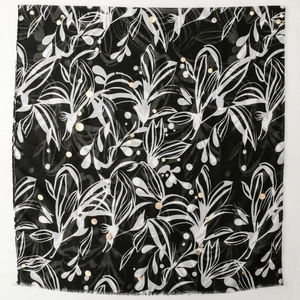 Elegant black bali gauze scarf with white floral patterns and gold metallic dots