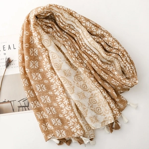 Close-up of geometric floral pattern and fringe tassels on a cotton linen blend scarf