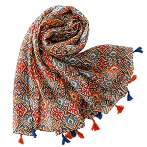 Bohemian silk scarf with geometric floral print and colorful tassels on white background