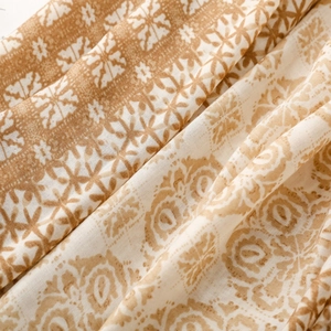 Detail of bohemian geometric print scarf with delicate linen texture and fringe finish
