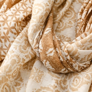 Detailed close-up of geometric pattern and fringe on linen-feel printed scarf shawl