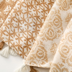 Close-up of bohemian pattern scarf with soft linen texture and elegant fringe details