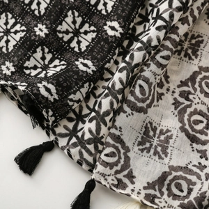 Close-up of geometric pattern scarf with detailed fringe tassels and woven texture