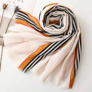 Detail of soft linen-touch scarf with colorful stripes and fine fringe edges
