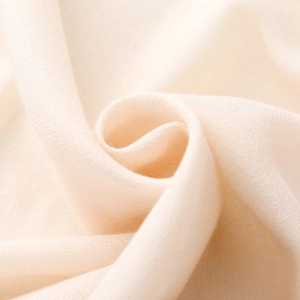 Macro shot of cream beige striped fabric showing soft cotton linen texture and drape