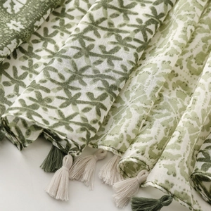 Close-up of green geometric print cotton linen scarf with soft fringe details