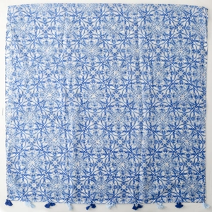 Blue and white bohemian porcelain pattern shawl with tassel fringe edges in flat lay
